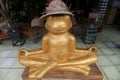 Golden frog statue in a meditating pose