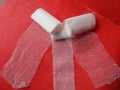 Gauze rolls for wound treatment with red background