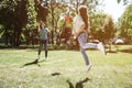 A picture of girl who has caughted frisbee with her hand. She made a jump to catch it. Her mom is very happy about that. Royalty Free Stock Photo