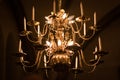 gold-plated chandelier hangs in the old church near the icons. Modern lamps are like candles Royalty Free Stock Photo