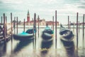 Picture with gondolas moored on Grand Canal near Saint Mark square, in Venice Italy with Church of San Giorgio Maggiore in the Royalty Free Stock Photo