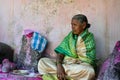 Picture of grandmother who is priest in a hindu temple wearing traditional cloths