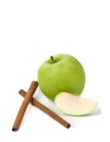Picture of green apple and sticks of cinnamon on the white back Royalty Free Stock Photo