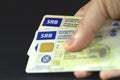 BELGRADE, SERBIA - MARCH 22, 2023: Selective blur on hand holding Serbian driving licence (vozacka dozvola) & registration