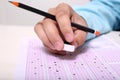 Picture of hand on the OMR sheet with hold pencil and eraser Royalty Free Stock Photo