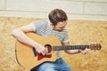 Handsome man playing guitar in studio Royalty Free Stock Photo