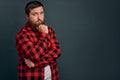 Picture of handsome young bearded man standing over gey wall background isolated. Looking camera Royalty Free Stock Photo