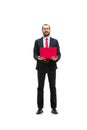 Picture of handsome young bearded man standing over white studio background with laptop Royalty Free Stock Photo