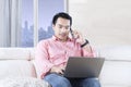 Handsome man with laptop in apartment Royalty Free Stock Photo