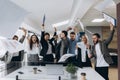 Picture of happy business team celebrating victory in office. Successful business team throws pieces of paper in modern office Royalty Free Stock Photo