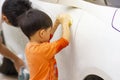 Happy child being a little helper by helping her daddy cleaning up the car.