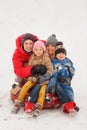 Picture of happy family with daughter and son sitting on tubing in winter Royalty Free Stock Photo