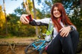 Picture of happy girl photographing herself in autumn forest Royalty Free Stock Photo