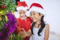 Happy girl with her brother decorates Christmas tree Royalty Free Stock Photo