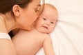 Picture of happy mother with adorable baby lying on bed Royalty Free Stock Photo