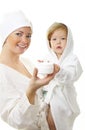 Picture of happy mother with baby holding cream