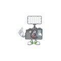 A picture of happy photo camera with lighting speaking on the phone Royalty Free Stock Photo