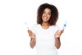 African lady holding toothbrush with toothpaste. Royalty Free Stock Photo