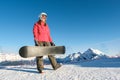 Picture of happy young lady snowboarder on the slopes