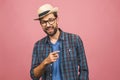 Picture of happy young man standing isolated over pink background