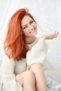 Picture of a happy young woman with gift box, pretty red-haired girl portrait with christmas present Royalty Free Stock Photo