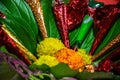 Picture of henna cone kept on bowl decorated with flowers and leafs