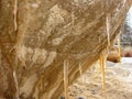 Picture with icicles on sandstone wall, blurred background