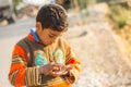 Poor boy counting coins in his hands