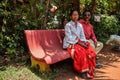 Picture of Indian couple seating on bench at garden and posing for photo