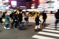 crowds of people crossing a city street at night in Tokyo, Japan Royalty Free Stock Photo