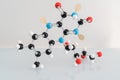 Isolated vitamin B2 made by molecular model with reflection on white background. Riboflavin chemical formula with colored atoms an