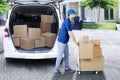 Italian man courier pushing a trolley Royalty Free Stock Photo