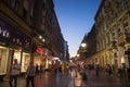 Kneza Mihailova street at night, crowded, with blurred people rushing.