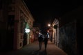 NOVI SAD, SERBIA - MARCH 26, 2022: Selective blur on the Laze Teleckog street at night with blurred young people, couple, passing