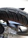 a picture of a leaking motorcycle tire punctured by a nail