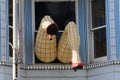 Legs with nylons sticking out of a window in San Francisco California