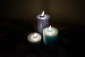 Three lit candles illuminating the picture Royalty Free Stock Photo