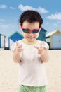 Happy little girl wearing sunglasses on the beach Royalty Free Stock Photo