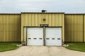 Loading dock doors at a yellow warehouse building Royalty Free Stock Photo