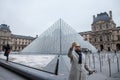 Tourist taking a selfie portrait in front of the Louvre Pyramid. Louvre pyramid Pyramide du Louvre is one of the main attraction