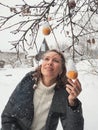 Picture of lovely middle-aged woman with frozen apple twig in winter. Rejuvenating apples. Withered skin of a rotten apple. Old Royalty Free Stock Photo