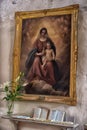 picture of the Madonna and Child on the wall of the church and prayer underneath Royalty Free Stock Photo