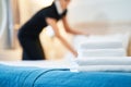 Maid making bed in hotel room Royalty Free Stock Photo