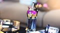 Picture with make up brushes of professional beautician. Bridal set of cosmetic products lie on table.