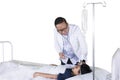 Pediatrician checks patient temperature on studio Royalty Free Stock Photo