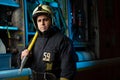 Picture of man firefighter with pick near fire truck Royalty Free Stock Photo