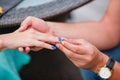 Picture of man putting engagement silver ring on woman hand, outdoor. Royalty Free Stock Photo