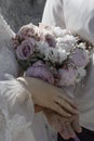 Picture of man and woman with bridal bouquet. Married couple holding hands, ceremony wedding day. Newly wed couple& x27;s Royalty Free Stock Photo
