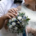 Picture of man and woman with bridal bouquet. Married couple holding hands, ceremony wedding day. Newly wed couple& x27;s Royalty Free Stock Photo