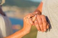 Picture of man and woman with wedding ring.Young married couple holding hands, ceremony wedding day. Newly wed couple`s hands wit